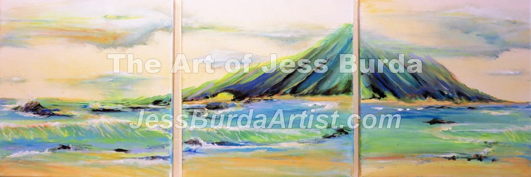 Green mountain peak with waves and sand in foreground
